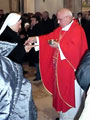 Mons. Ivan Prendja gives the eucharist to believers